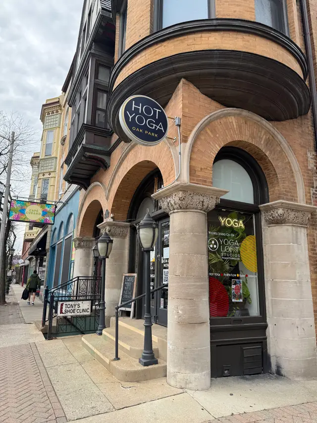 The corner building on Oak Park Avenue with the round Hot Yoga blade sign over the brick bay